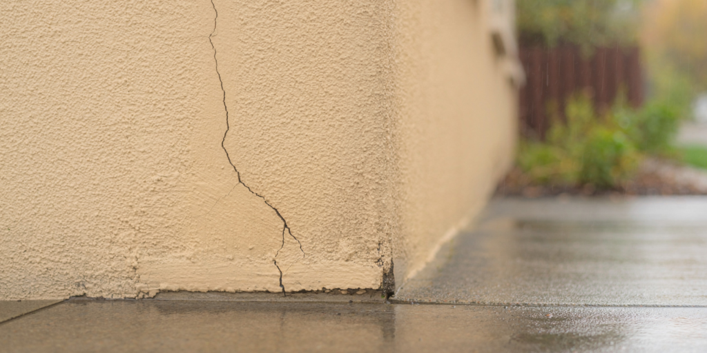 Cracked wall on the outside of a home Cracked wall on the outside of a home